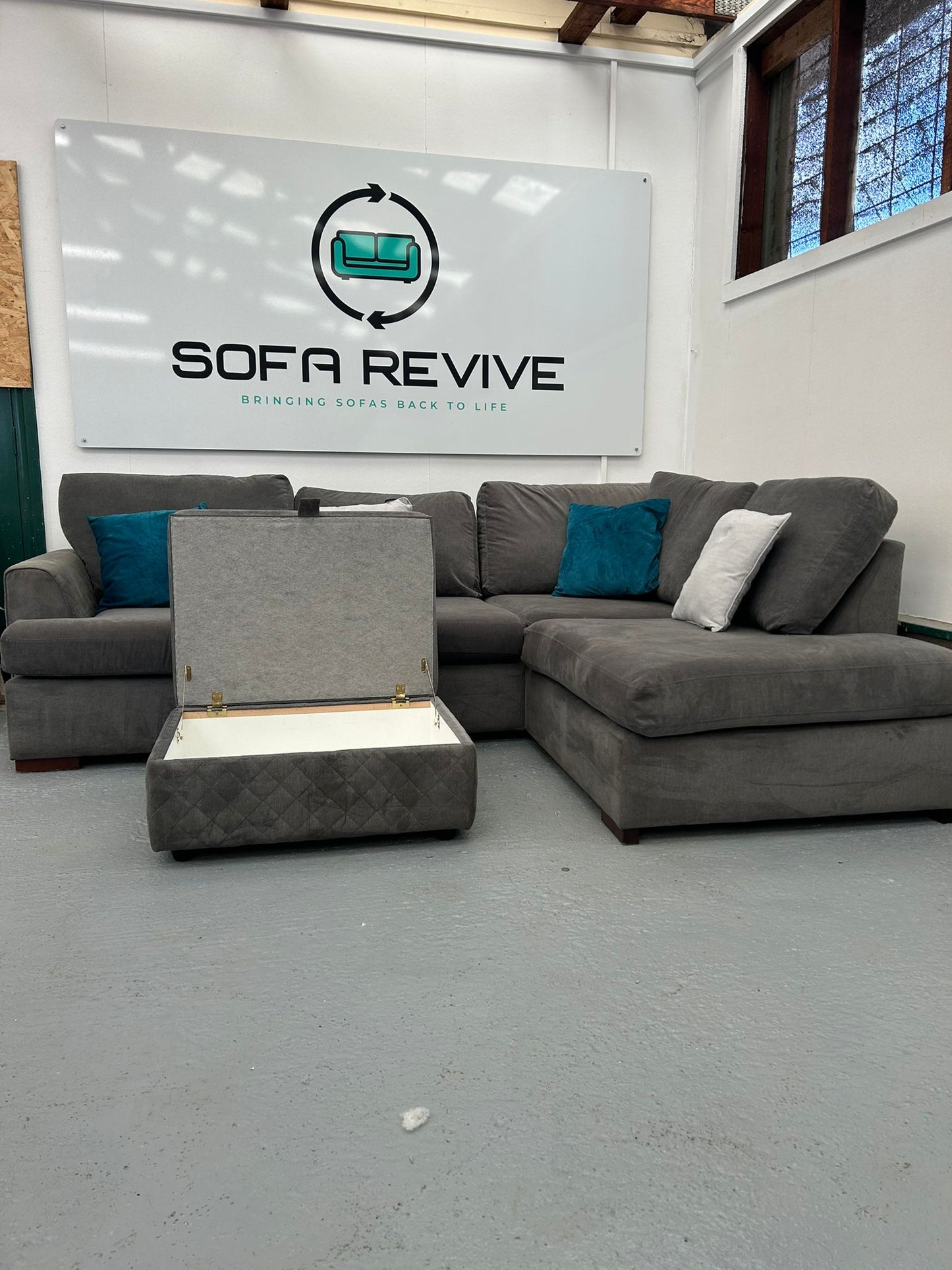 Grey DFS Orka corner sofa with matching storage footstool