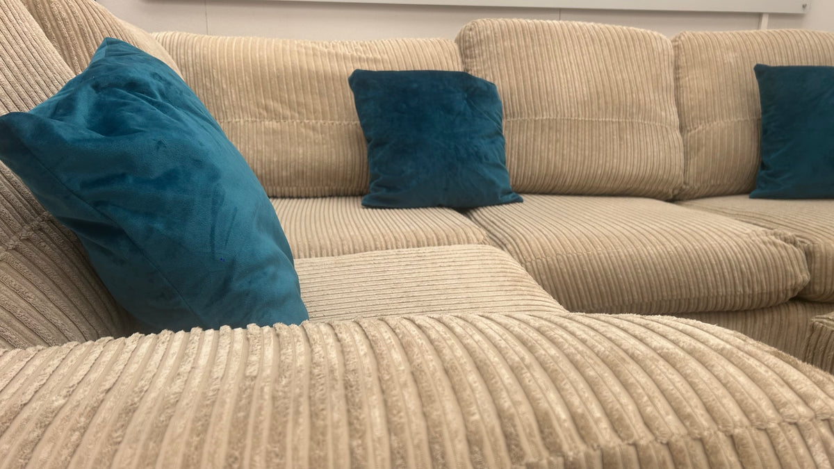 Beige cord DFS corner sofa bed with matching footstool